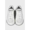 White sneakers with brand logo