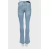 Flared jeans with gold buttons