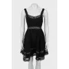Dress decorated with eyelets on straps