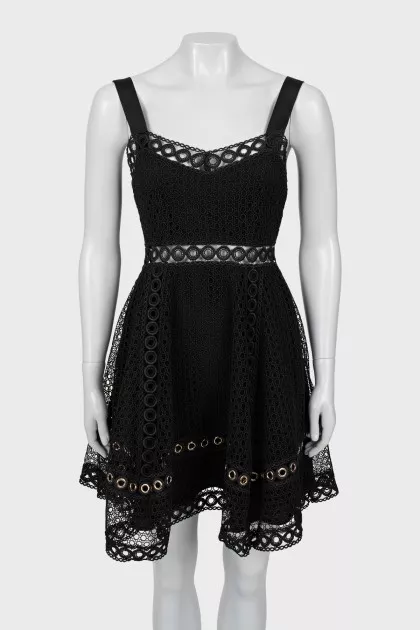 Dress decorated with eyelets on straps