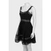 Dress decorated with eyelets on straps
