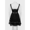 Dress decorated with eyelets on straps