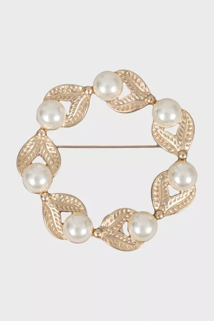 Golden brooch decorated with beads