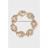 Golden brooch decorated with beads