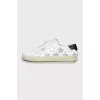 Leather sneakers decorated with stripes