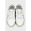 Leather sneakers decorated with stripes