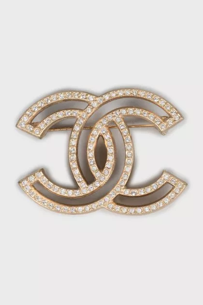Golden brooch decorated with rhinestones