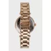 Golden watch with rhinestones on the dial