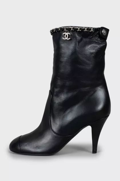 Ankle boots decorated with chain on a stiletto heel