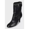 Ankle boots decorated with chain on a stiletto heel