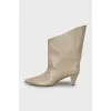 Beige ankle boots with a figured heel