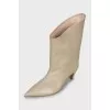 Beige ankle boots with a figured heel