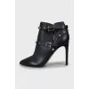 Leather ankle boots decorated with spikes