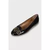 Patent leather ballet flats decorated with eyelets