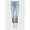 Light blue jeans with raw hem