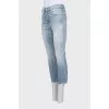 Light blue jeans with raw hem