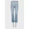 Light blue jeans with raw hem
