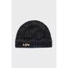 Knitted hat with a golden brooch