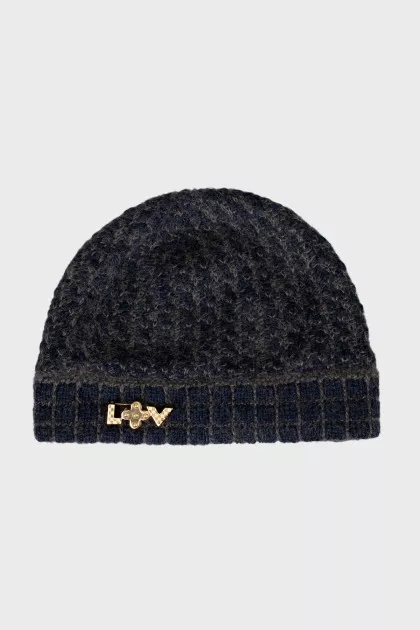 Knitted hat with a golden brooch