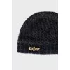 Knitted hat with a golden brooch