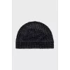 Knitted hat with a golden brooch