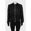 Black bomber jacket with golden zipper