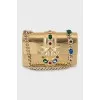 Golden bag decorated with rhinestones