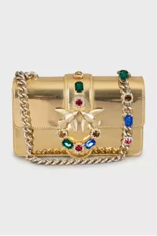 Golden bag decorated with rhinestones