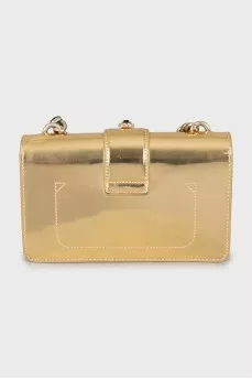 Golden bag decorated with rhinestones