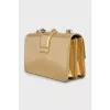 Golden bag decorated with rhinestones