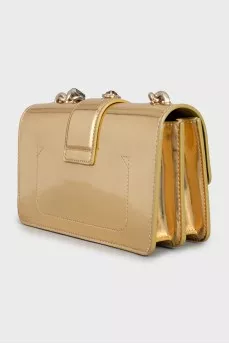 Golden bag decorated with rhinestones