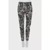 Trousers with stitched creases in a print