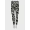 Trousers with stitched creases in a print
