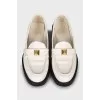 Leather loafers decorated with spikes