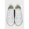 White leather sneakers with brand logo