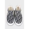 Textile slip-ons with signature print