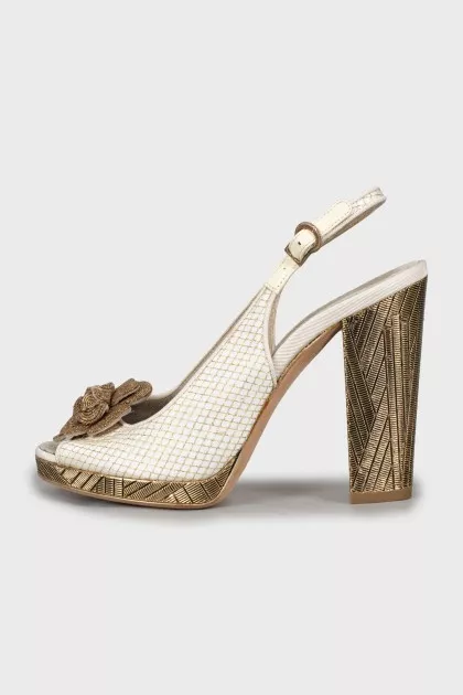 Sandals with metal heel decoration