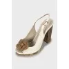 Sandals with metal heel decoration