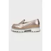 Gold loafers with embossed leather