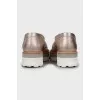 Gold loafers with embossed leather