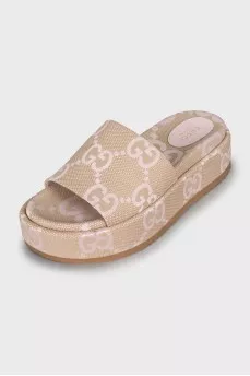 Textile slippers with a signature print