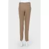 Shortened beige trousers with arrows