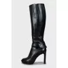 Leather boots decorated with a strap