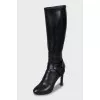 Leather boots decorated with a strap