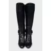 Leather boots decorated with a strap