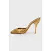 Golden Mules with a stiletto