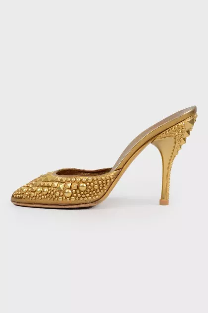 Golden Mules with a stiletto
