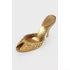 Golden Mules with a stiletto