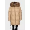 Down jacket with fur on the hood and a tag