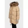 Down jacket with fur on the hood and a tag